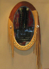 Oval mirror with leather wrapping, brass studs and extended fringe.